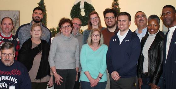 Alumni standing with President Sharon L. Gaber